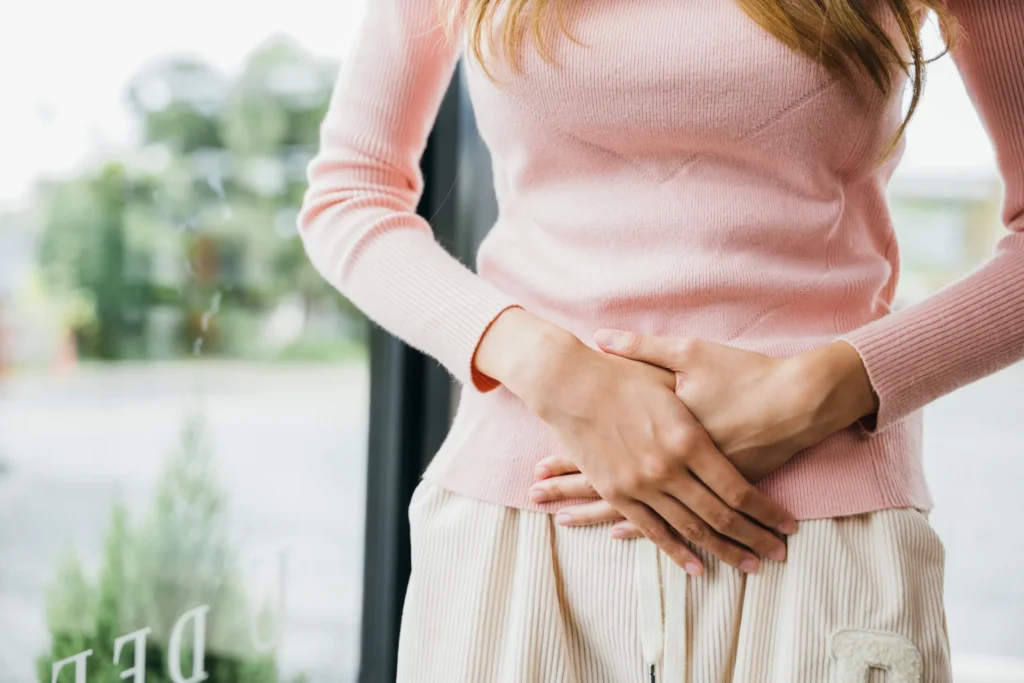 woman with abdominal pain indoor 2026 03 19 10 32 21 utc