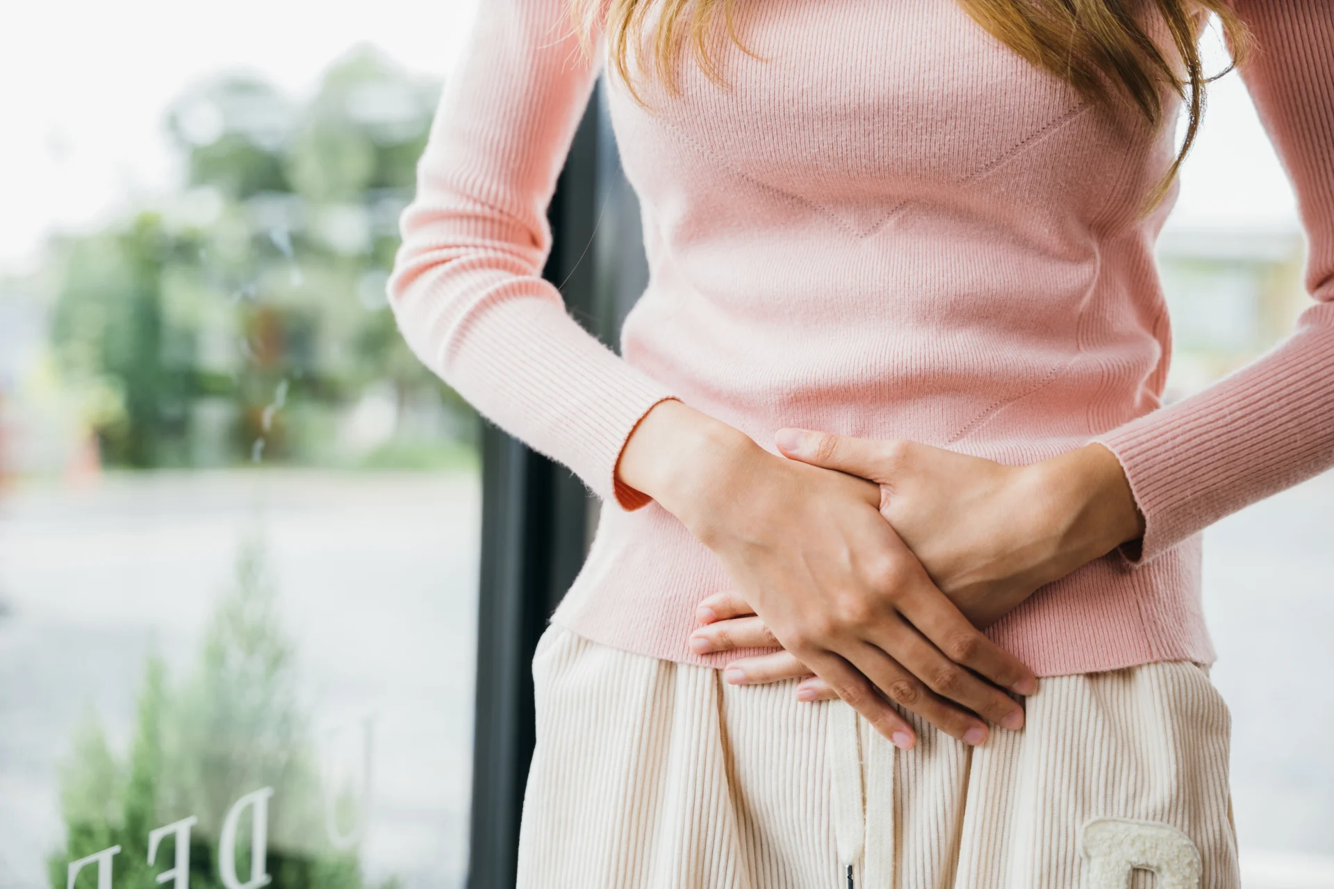 woman with abdominal pain indoor 2026 03 19 10 32 21 utc